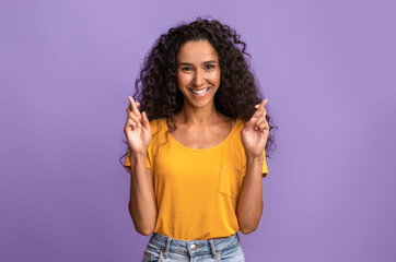 Cherished Wish. Positive Brunette Woman Crossing Fingers And Smiling, Begging For Luck