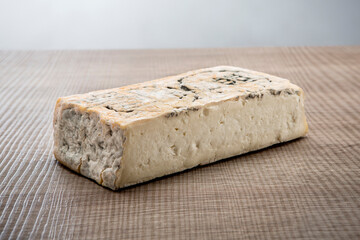 Italian aged cheese on wooden background
