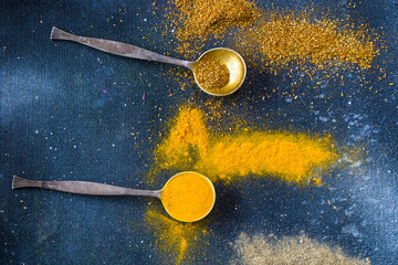 variation of spices on the vintage silver spoons, all spices on the table
