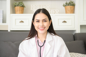 Portrait of Female doctor with stethoscope at office and smiling at camera.