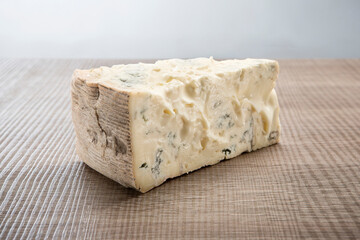 Italian aged cheese on wooden background