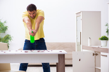 Young man and a lot of cockroaches at home