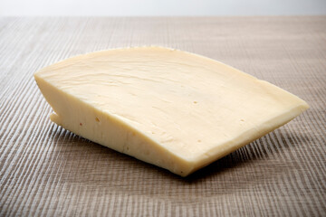 Italian aged cheese on wooden background