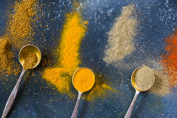 variation of spices on the vintage silver spoons, all spices on the table