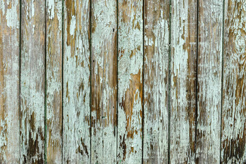 Naklejka premium The texture of the wooden planks has faded in the sun. Wooden wall in gray-brown tones. Old wood background, board textures with peeling paint. Brown wood texture.