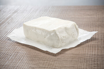 fresh italian white cheese on wooden background