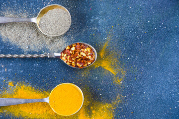 variation of spices on the vintage silver spoons, all spices on the table