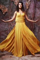 Fototapeta na wymiar young woman wearing yellow evening dress, romantic concept