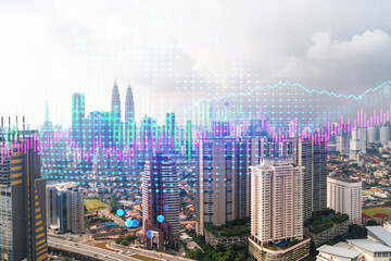 Financial stock chart hologram over panorama city view of Kuala Lumpur. KL is the business center in Malaysia, Asia. The concept of international transactions. Double exposure.