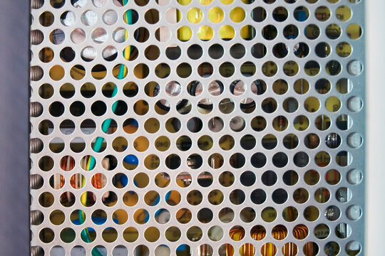 Radio components behind a gray metal grating.