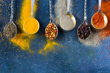 variation of spices on the vintage silver spoons, all spices on the table