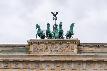 Quadriga of Victory, the teal statue with horses on top of the Brandenburg Gate on a winter day