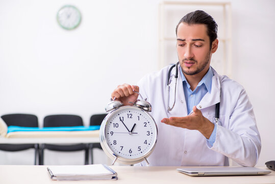 Young handsome male doctor working in the clinic