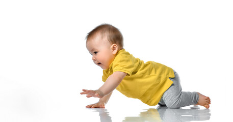 laughing baby boy crawling over white