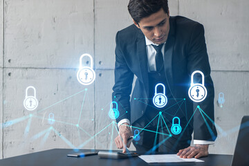 Businessman in office signs contract and lock hologram. Double exposure. Formal wear. Concept of...