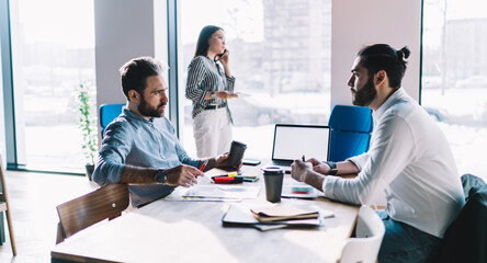 Colleagues discussing business issue in office