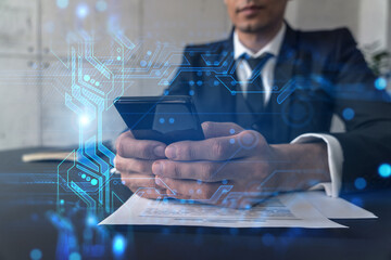 Businessman in office working with Smartphone, new technologies hologram to optimize the process, typing phone. Double exposure.
