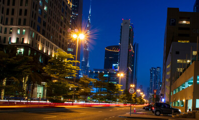 Fototapeta na wymiar Light trails on Dubai Financial Center road. Address Sky view and Ritz Carlton hotel can be seen in the picture
