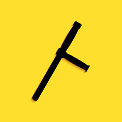 Black Police rubber baton icon isolated on yellow background. Rubber truncheon. Police Bat. Police equipment. Long shadow style. Vector.
