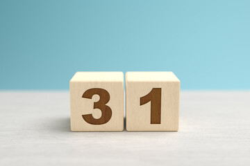 Wooden toy blocks forming the number 31.