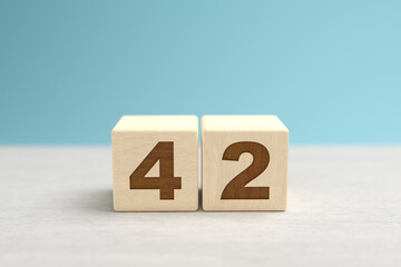 Wooden toy blocks forming the number 42.