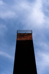 Old chimney with shadow and blue sky