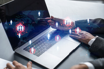 Man and woman working together on international business project. Blue infographic hologram of planet earth. World map. Multiexposure.