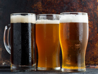 Three different Beers in glasses, dark ale, wheat beer and lager light beer
