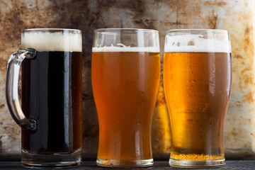 Three different Beers in glasses, dark ale, wheat beer and lager light beer