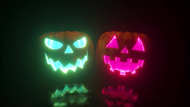 Halloween, two pumpkins with a scary face glow from the inside in two different colors. Bright neon lighting. Seamless loop 3d render
