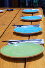 Luxury outdoor Table setting. Table in the restaurant in the open air with cutlery and plates.
