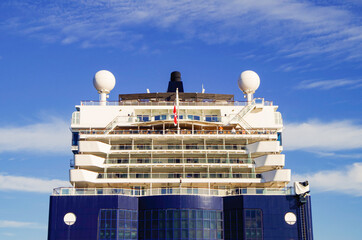Modern luxury cruiseship or cruise ship liner anchoring on blue sea in bay offshore of Bar Harbor,...