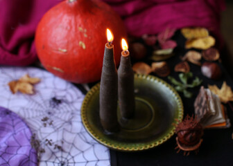 burning candles, pumpkin and witches hat. Halloween concept,