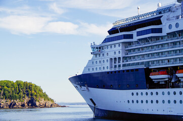 Modern luxury cruiseship or cruise ship liner anchoring on blue sea in bay offshore of Bar Harbor,...