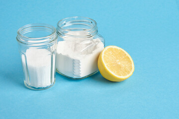 cans with soda and citric acid and lemon on blue background copy space, eco friendly detergents concept, ingredients for baking