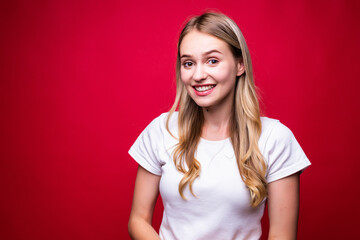 Portrait of young happy woman isolated over red background