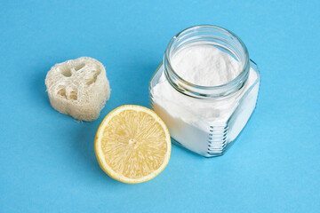 lemon, loofah and a can of soda on a blue background