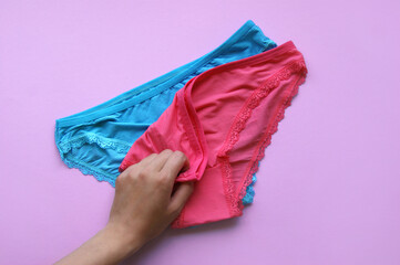 Set of women's panties on a pink background. Pink and blue underwear.