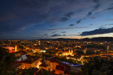 Fototapeta na wymiar Cityscape of Graz with Mariahilfer church and historic buildings, in Graz, Styria region, Austria, by night.
