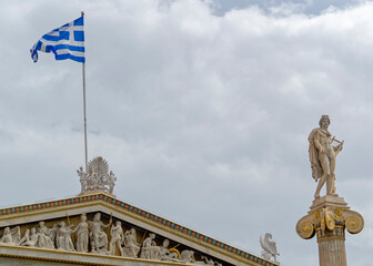 Apollo the ancient Greek god and Greek flag on the Athens academy building