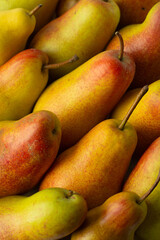 Ripe, yellow-red pears lie tight, top view.