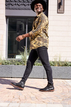 african american famous man walk in city streets, wearing fashionable clothes. enjoy free time, after concerts and performance