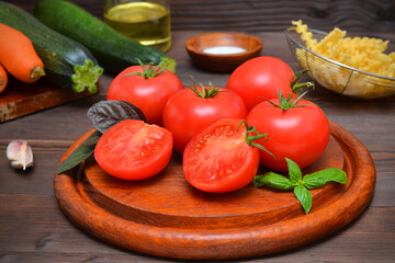 fresh tomatoes with basil and other vegetables for making dinner