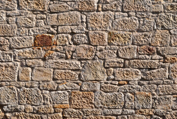 Rough Textured Stones of Old Wall with Single Brown Rock 