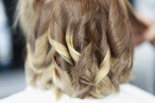 Evening hairstyle styling curls with curling iron. Training courses for evening and wedding hairstyles concept