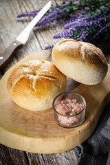 Kaiser buns on cutting board.