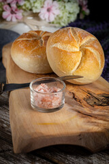 Kaiser buns on cutting board.