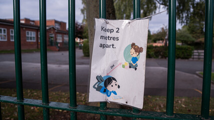 A school sign advising 2 metres distance during the COVID-19 pandemic