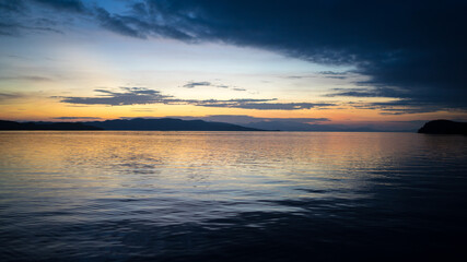 Fototapeta premium Beautiful dramatic sunset over the sea. Evening on the ocean. Freedom, peace and meditation concept. Soft focus