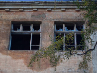 broken Windows after the bombing and fire. airstrike. broken Windows. abandoned areas of military operations.